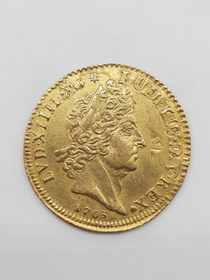 une pièce d'or portant le portrait d'un homme