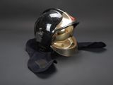 black and gold helmet and gloves on a gray surface