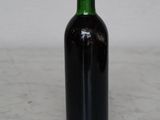 a bottle of wine sitting on a marble counter top