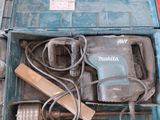 a blue tool box with a hammer and other tools in it