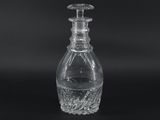 a close up of a clear glass bottle on a black background