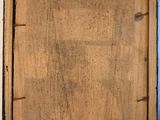 an old wooden picture frame with a piece of wood hanging from it