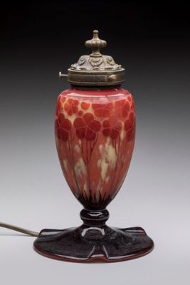 an image of a red and white lamp on a black stand