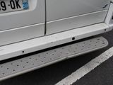 a white van parked in a parking lot with a number plate on it