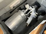 a metal container with a metal spray gun inside of it