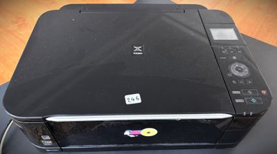 a black printer sitting on top of a wooden table