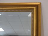 a mirror hanging on the wall in a room