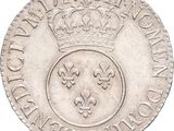 a close up of a coin with a crown on top of it