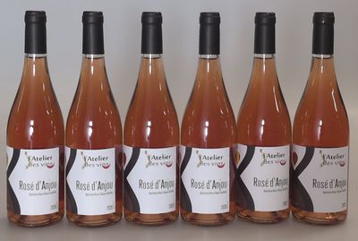 six bottles of wine are lined up on a table