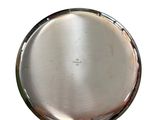 a silver plate on a white surface with a white background