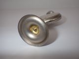 a close up of a silver cuff with a gold button