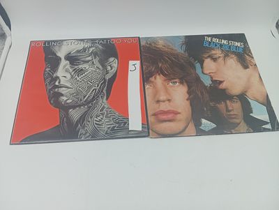 Deux CD des Rolling Stones sont posés sur une table blanche