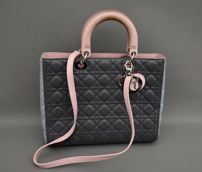 un sac à main noir et rose avec une bandoulière rose