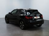 the back of a black car in a white room