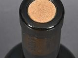 a close up of a bottle of wine with a cork cap