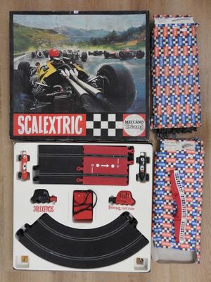 le contenu d'une voiture de course Scalextric est étalé sur le sol