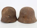 two helmets that are sitting next to each other on a white surface