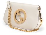 a white leather bag with a gold buckle and chain