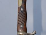 a close up of a knife with a wooden handle