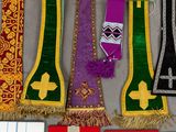 many different colored ties hanging on a wall