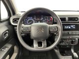 the interior of a car with a steering wheel and dashboard controls