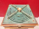 a gold and green box with a clock on top of it