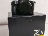 the camera is sitting on top of the box on the table