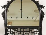 an image of a mirror with a black frame on a white wall