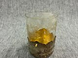 a glass with a yellow substance in it on a table