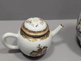 three different types of teapots and saucers are sitting on a table