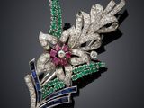 a diamond, emerald and sapphire flower broochle