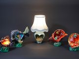 a lamp that is sitting next to a bunch of figurines