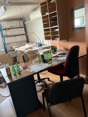 an image of a messy office with a lot of clutter on the desk