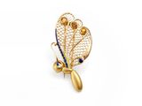 a close up of a gold broochle with blue stones on it
