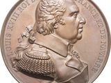 an image of a silver coin with a portrait of a man on it