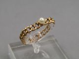 an image of a gold ring with a pearl on it