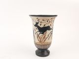 a vase with a black bird on it on a white background