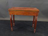 a small wooden table with a green stripe on the top