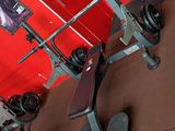 a gym equipment set up in a room with a red wall