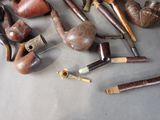 many different types of smoking pipes on the table