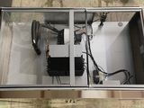 an overhead view of a metal box with wires in it