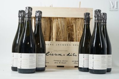 trois bouteilles de vin sont posées devant une caisse en bois