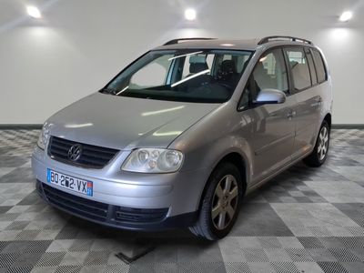 the silver van is parked on a checkered floor in the garage