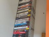 a tall stack of dvds sitting on a shelf