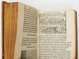 an open book with a picture of a town on it