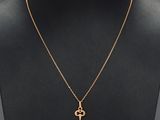 a gold key necklace on a mannequin mannequin mannequin mannequin mannequin mannequin mannequin mannequin manne