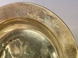 a close up of a silver plate with a picture on it