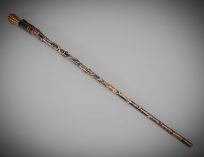 a close up of a wooden stick with a design on it