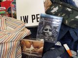 a pile of clothing and other items on a bed