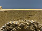 a close up view of a clock on the side of a building